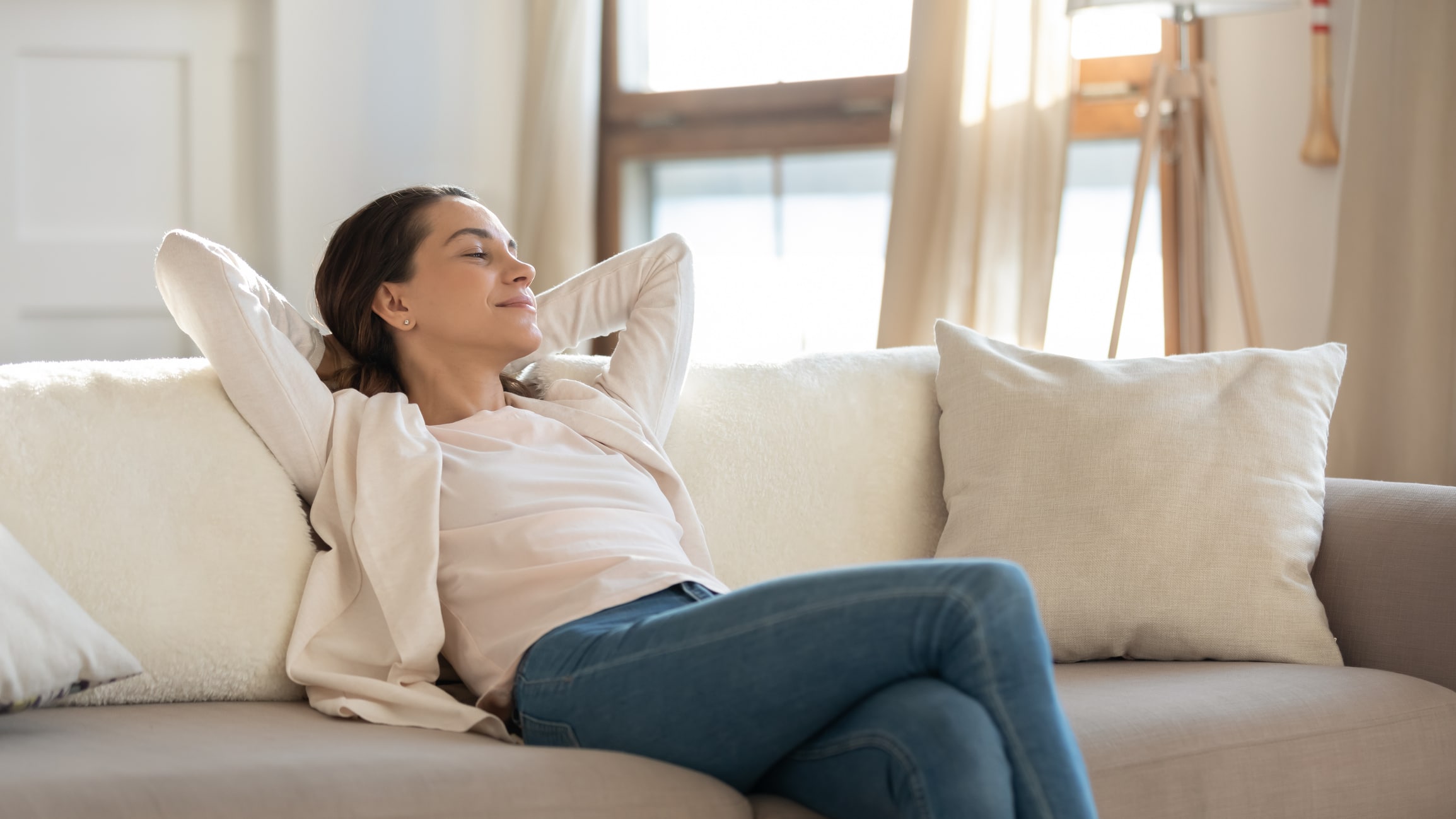 Young Woman enjoying her home with an air purification system system.